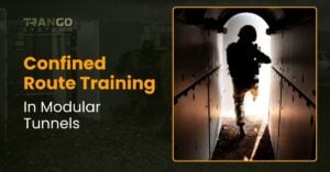 Trainee moving through a Trango modular tunnel section toward a bright exit during confined route training